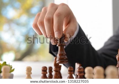Businessman playing chess, closeup