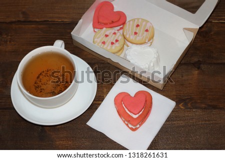 Cozy and tasty romantic breakfast with tea and biscuits in the shape of a heart love symbol