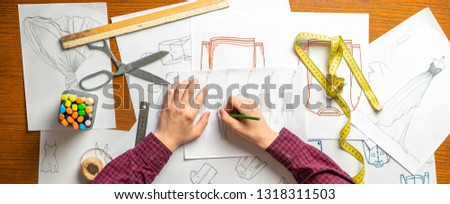 overhead top view designer doing clothes sketch