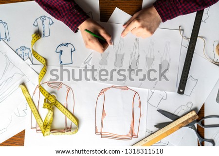 overhead top view designer doing clothes sketch
