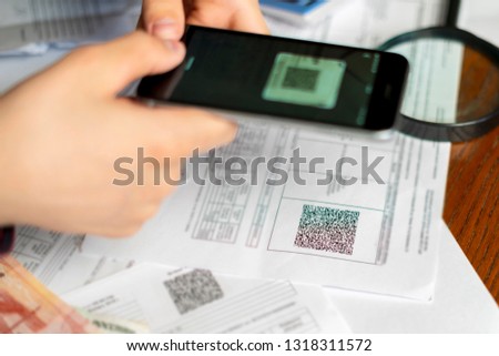 persons hand hold spartphone scanning qr code or barcode