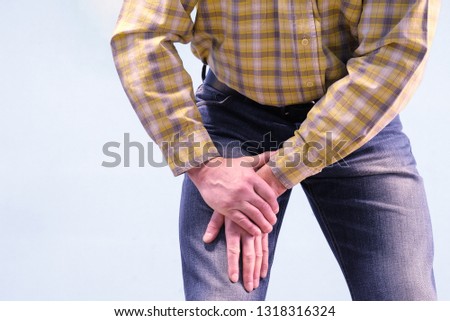 Muscle pain in the thigh. The man grabbed his thigh in a fit of pain. Suffers from diseases of joints and ligaments. The concept of health. Royalty-Free Stock Photo #1318316324