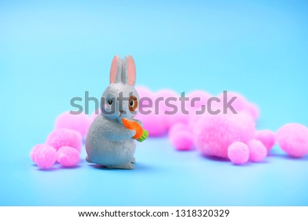 Cute toy rabbit with carrot. Easter holiday background, spring season. Easter lovely rabbit close up. copy space.