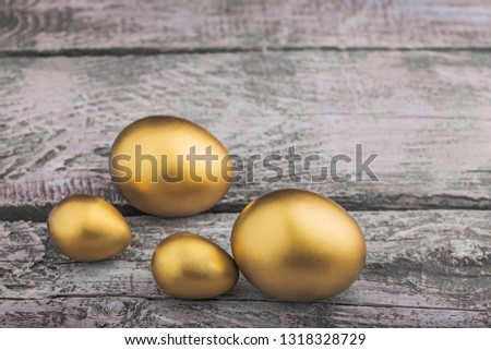 Background of Golden eggs on a wooden surface