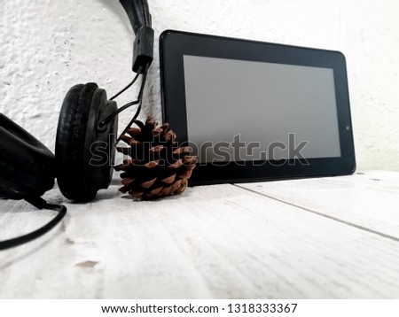 Tablets and headphones on a white wooden table