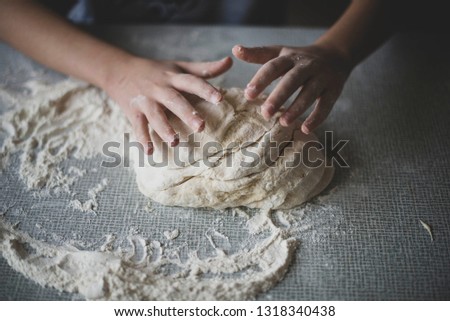 cooking a dough. hands in flour. food on the table Royalty-Free Stock Photo #1318340438