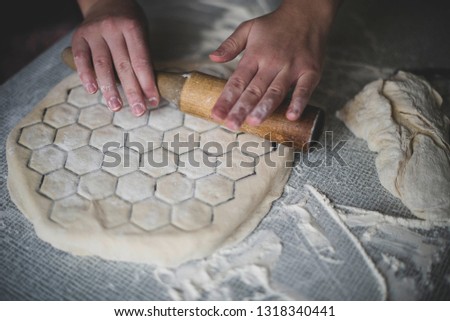 cooking a dough. hands in flour. food on the table Royalty-Free Stock Photo #1318340441
