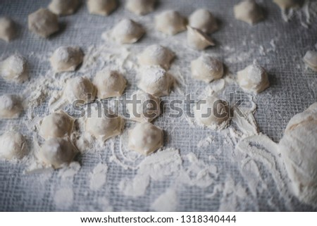 cooking a dough. hands in flour. food on the table Royalty-Free Stock Photo #1318340444