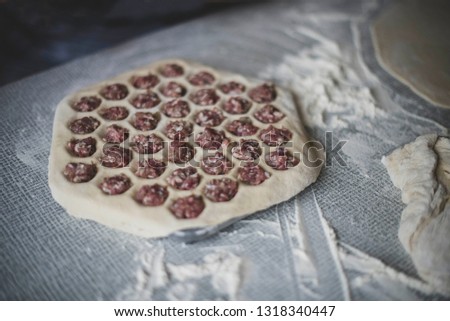 cooking a dough. hands in flour. food on the table Royalty-Free Stock Photo #1318340447