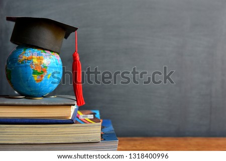 hat graduation on globe model for concept education and scholarships Royalty-Free Stock Photo #1318400996