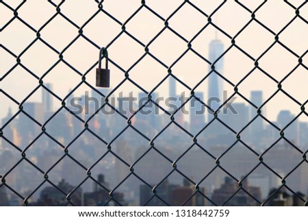 New York city behind steel mesh wire fence. Concept 
