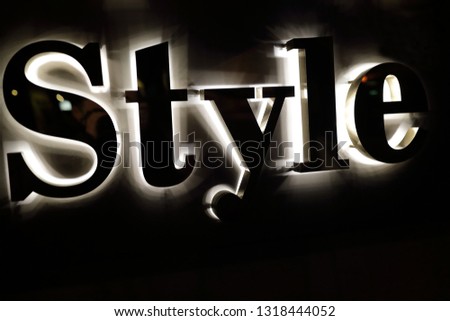 Details of style sign on wall at night