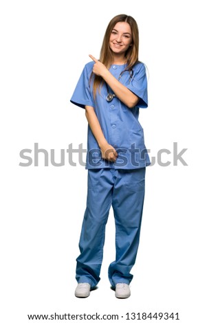 Full body Young nurse pointing to the side to present a product on isolated background