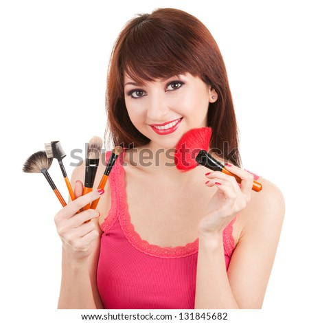 Young woman with brushes for makeup isolated on white background