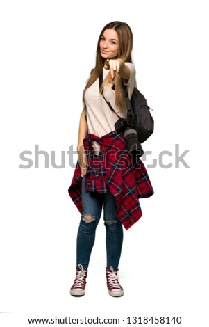 Full body Young photographer woman points finger at you with a confident expression on isolated background
