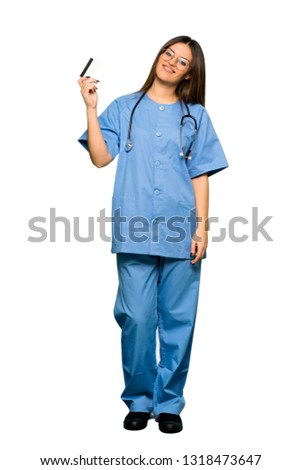 Full body of Young nurse holding a credit card