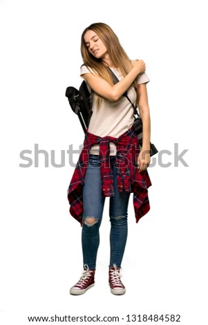 Full body Young photographer woman suffering from pain in shoulder for having made an effort on isolated background