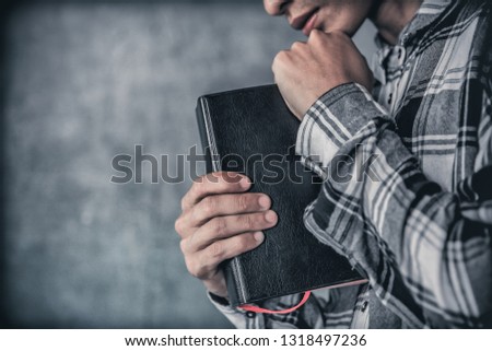 Man holding a bible and praying. christian concept.