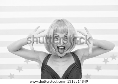 Comic actress concept. Woman playful mood having fun. Lady actress practicing performance. She likes bright outfit. Girl posing striped background of studio. Lady red ginger wig posing in blue dress.