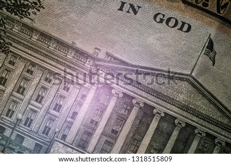 Macro. Part of the Image of the US Department of the Treasury Building with a flag and the inscription In God. Close-up. Ten-dollar US bill on the reverse side. High detail texture.