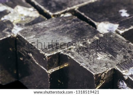 Natural pieces of pyrite cubes on a black background isolated