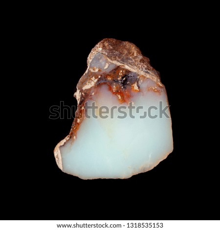 Natural piece of blue opal on a black background isolated