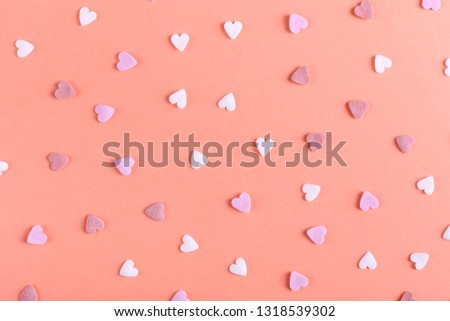 The heart shaped powder like candy is scattered on table. Happy Easter concept greeting card design.