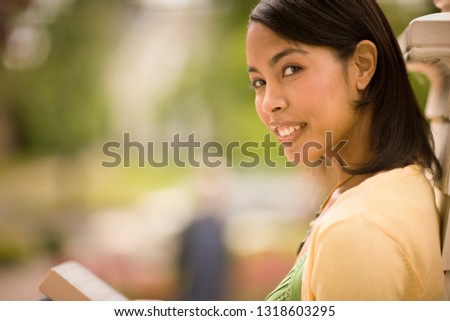 Young woman smiles as she poses for a portrait.