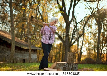 Woman chopping wood.
