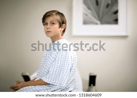 Portrait of a young boy waiting for an examination in a doctor's office.