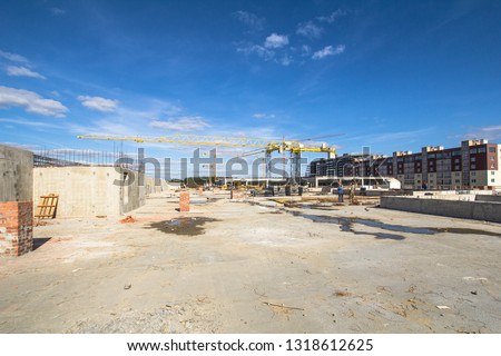 

Construction area with yellow cranes at summer time.   Royalty-Free Stock Photo #1318612625
