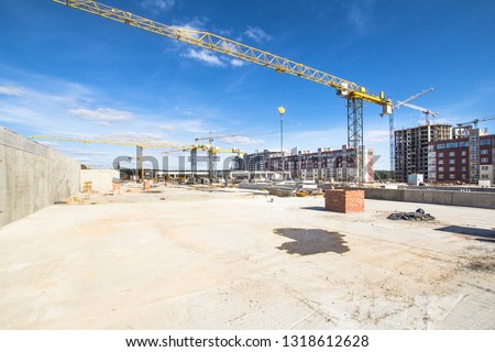 
Construction area with yellow cranes at summer time.   Royalty-Free Stock Photo #1318612628