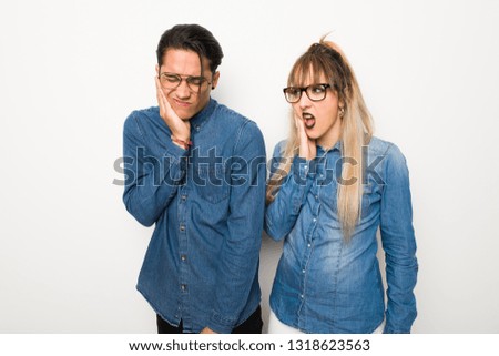 Young couple with glasses with toothache