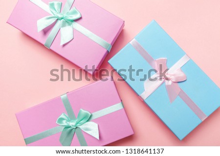 Christmas New Year birthday valentine celebration present romantic concept. Three gift boxes wrapped pink blue paper isolated on pink pastel colorful trendy background. Flat lay top view copy space