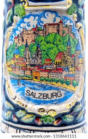 Up close shot of the art on the side of a beer stein depicting Salzburg, Austria.