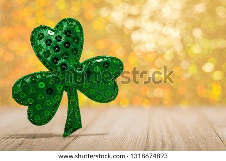 Sequin Shamrock for St. Patrick's Day, Spring, Wealth, Luck, on beautiful gold bokeh background, room for text / copy
