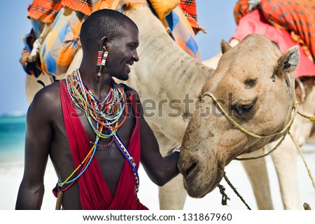 Maasai sitting by the ocean on the beach Royalty-Free Stock Photo #131867960