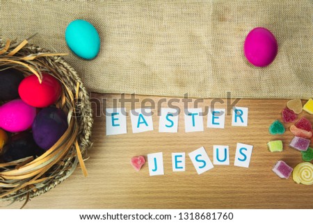 Easter composition with color  eggs on  wooden background, space for text.