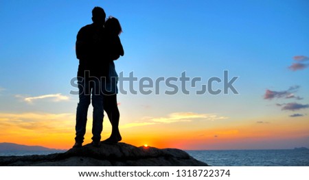 Beautiful Young Couple in Love Hug at Sunset time with Sea view
