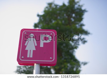 Lady toilet pink sign and the tree background