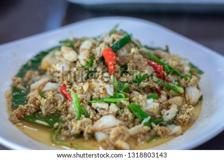 Focus in the middle of the picture and around the blurred. menu Fried crab with curry powder on white plate