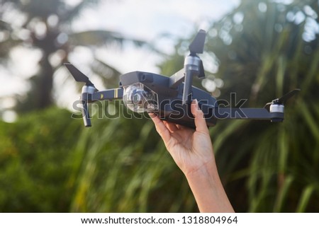 Drone in the female hand. Close-up. Sri Lanka. Girl launches drone.