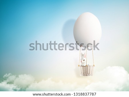 The rabbit is in 3D egg hot air balloon floating up to sky, Mid-autumn festival concept, Easter concept Royalty-Free Stock Photo #1318837787