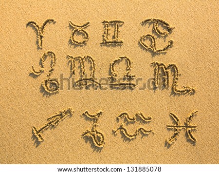 Set of zodiac signs drawn on the facture beach sand. Royalty-Free Stock Photo #131885078