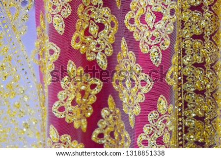deep pink red sari, saree or shari with golden lace.