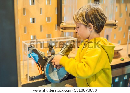 Smart boy scientist making physical experiments in the laboratory. Educational concept. Discovery