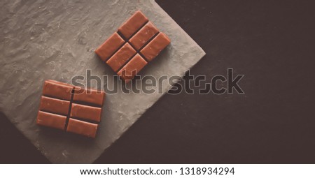 Sweet swiss chocolate candies on a stone tabletop, flatlay - desserts, confectionery and gluten-free organic food concept.  All you need is chocolate