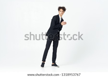 Business man in a suit in full growth curly hair      