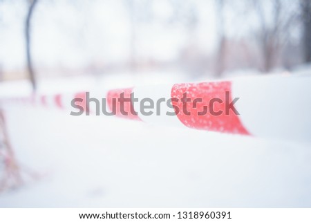 close-up tape outdoors, closed territory. fence red white tape