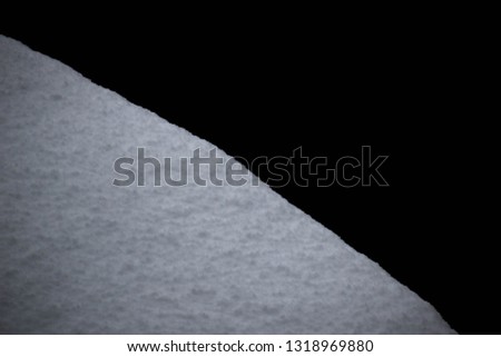 The picture is divided into half snow and half dark background